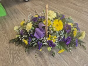 Purple and Yellow fresh flowers in basket